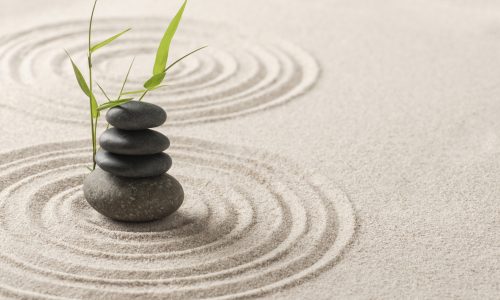 Stacked zen stones sand background art of balance concept