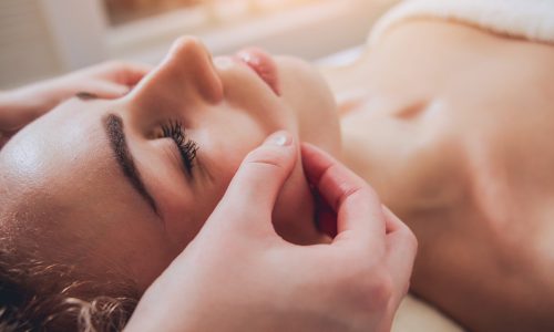 Beautiful woman in spa salon getting facial massage. Relaxing